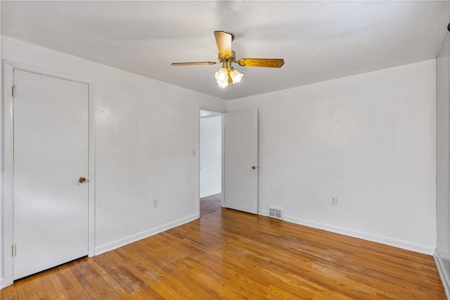 empty room featuring ceiling fan and light wood-type flooring