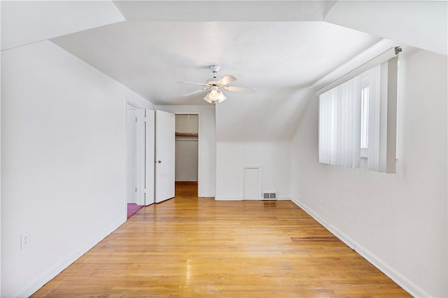 bonus room with lofted ceiling, light wood-type flooring, and ceiling fan