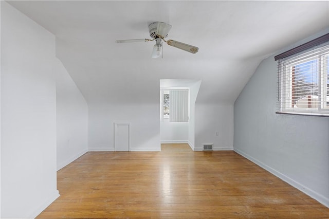 additional living space with lofted ceiling, ceiling fan, and light wood-type flooring