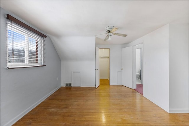 bonus room featuring ceiling fan, light wood-type flooring, and lofted ceiling