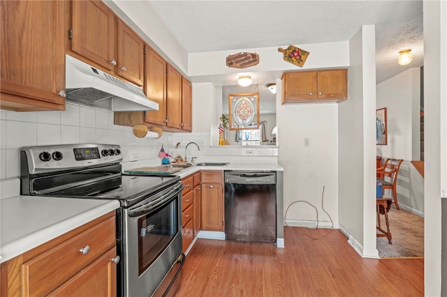 kitchen featuring a textured ceiling, electric stove, dishwasher, light wood-type flooring, and sink