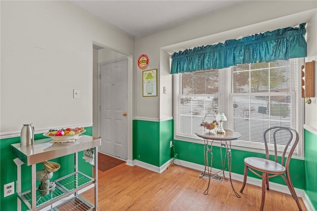 dining area featuring a healthy amount of sunlight and hardwood / wood-style floors