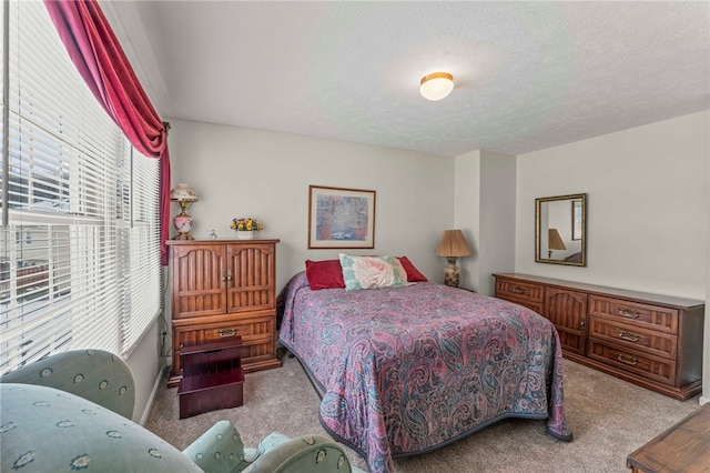 bedroom featuring a textured ceiling and light colored carpet