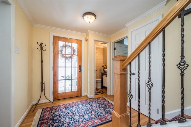 entrance foyer featuring crown molding and light hardwood / wood-style flooring