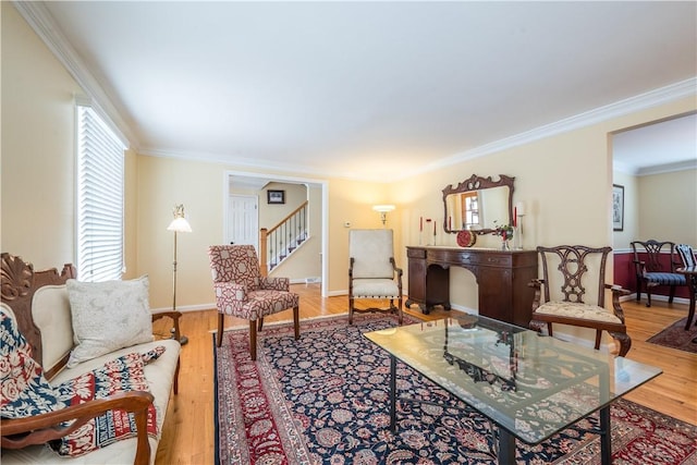 living room featuring hardwood / wood-style floors and crown molding