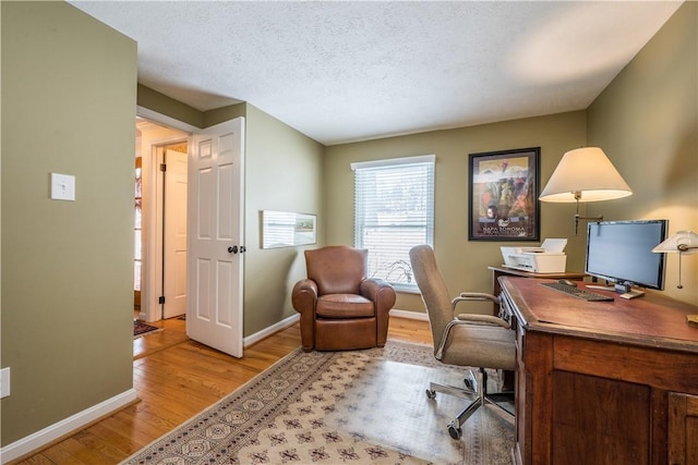 office featuring light hardwood / wood-style floors and a textured ceiling