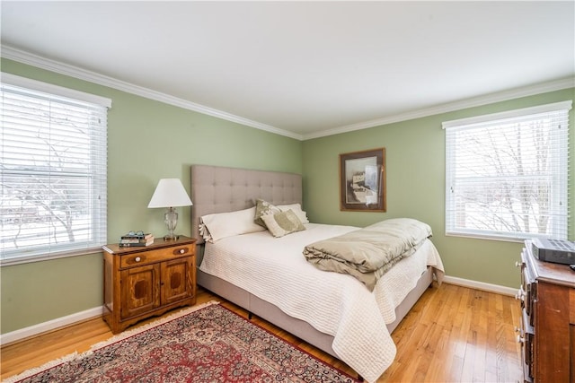 bedroom featuring light hardwood / wood-style flooring and crown molding