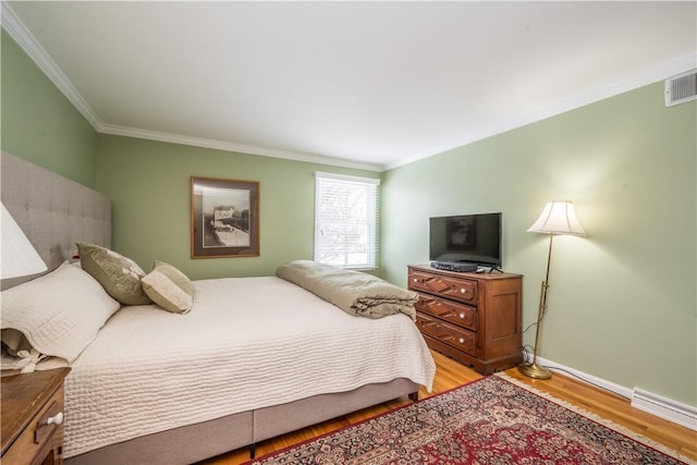 bedroom featuring light hardwood / wood-style floors and ornamental molding