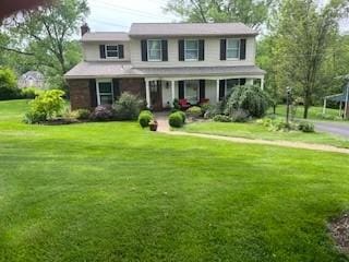 view of front of property with a porch and a front lawn