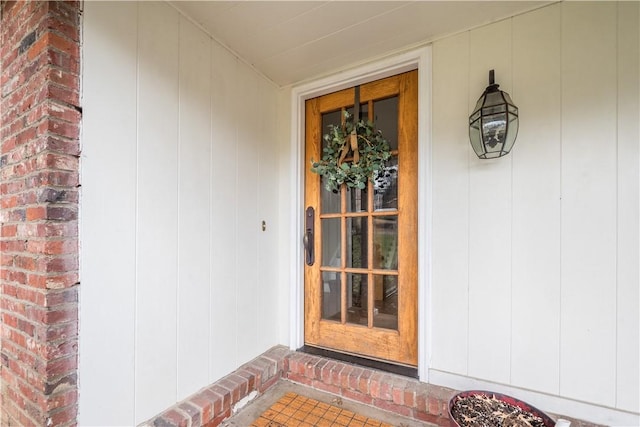 doorway to property with brick siding