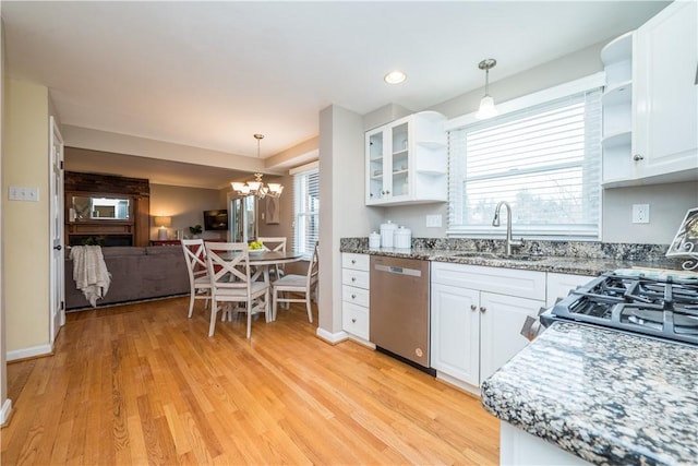 kitchen with open floor plan, dishwasher, a sink, and open shelves