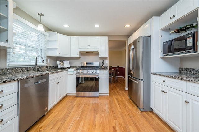 kitchen featuring stainless steel appliances, white cabinets, a sink, and open shelves