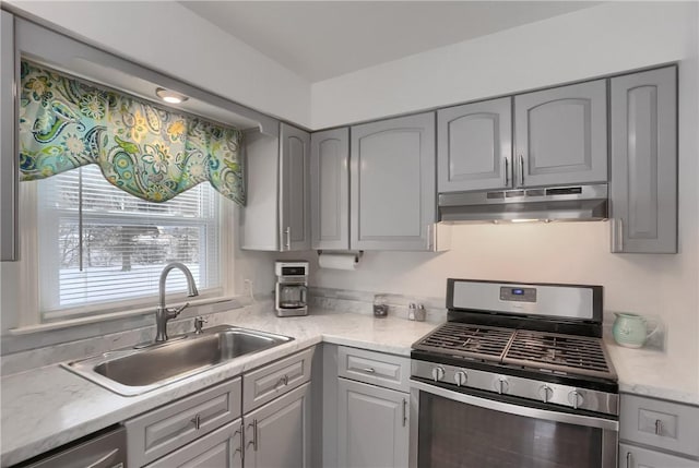 kitchen with stainless steel appliances, gray cabinets, and sink