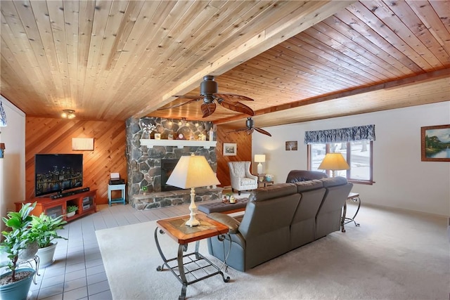 living room with a fireplace, ceiling fan, wood walls, wood ceiling, and beam ceiling