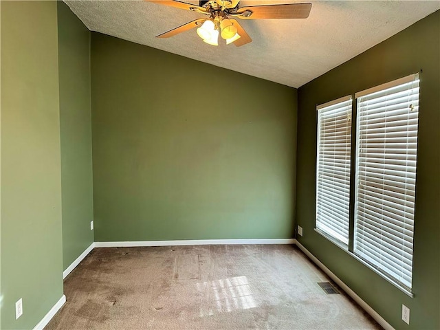 empty room featuring carpet flooring, a textured ceiling, and ceiling fan