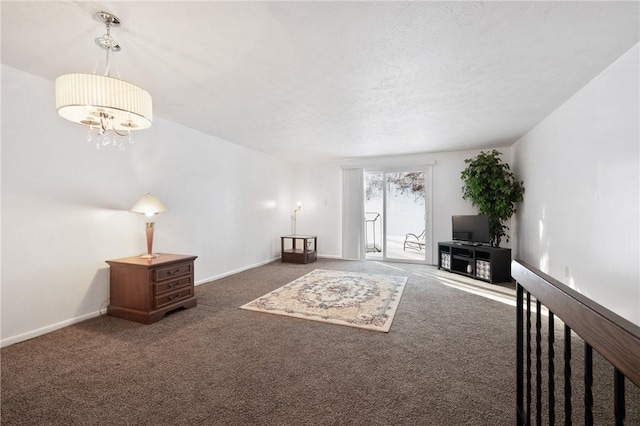 unfurnished living room with a notable chandelier and dark colored carpet