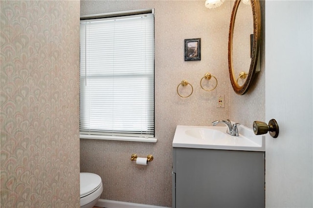 bathroom featuring toilet and vanity