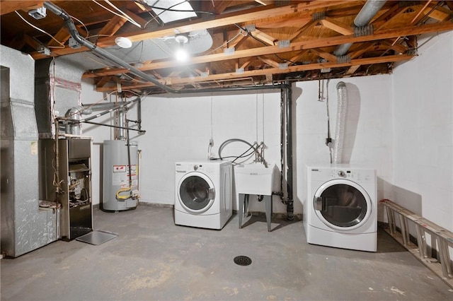 basement featuring sink, washing machine and dryer, and gas water heater