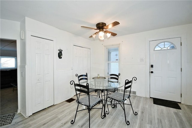 dining area featuring ceiling fan, light wood-type flooring, and plenty of natural light