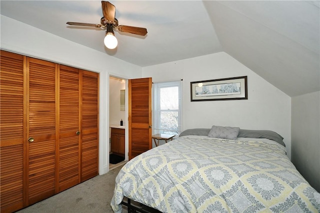 bedroom with vaulted ceiling, a closet, ceiling fan, and carpet