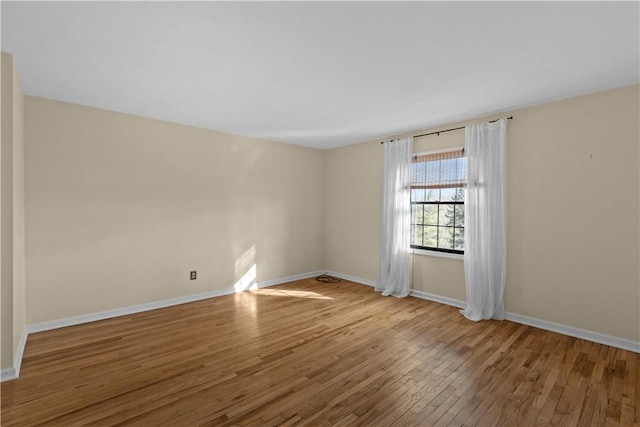 unfurnished room featuring hardwood / wood-style floors