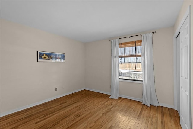 unfurnished bedroom featuring light hardwood / wood-style flooring and a closet