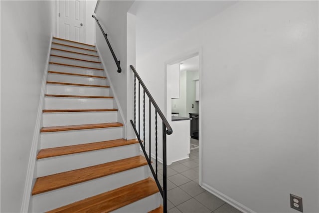 stairway featuring tile patterned flooring