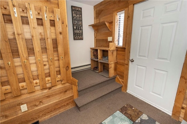 interior space with a baseboard heating unit and carpet