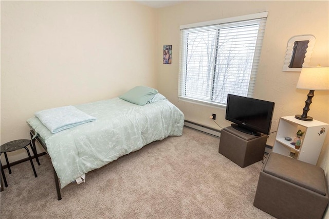 carpeted bedroom featuring a baseboard heating unit