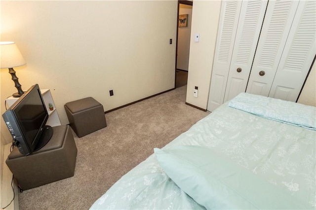 bedroom featuring a closet and light colored carpet