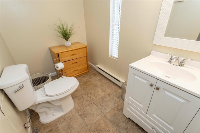 bathroom featuring baseboard heating, vanity, and toilet