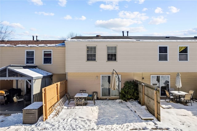 view of snow covered back of property