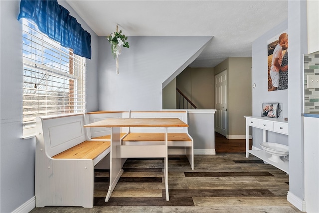 dining space with wood-type flooring