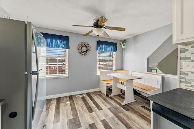 dining area with ceiling fan and hardwood / wood-style floors