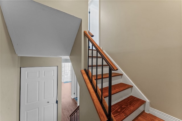 staircase featuring hardwood / wood-style floors