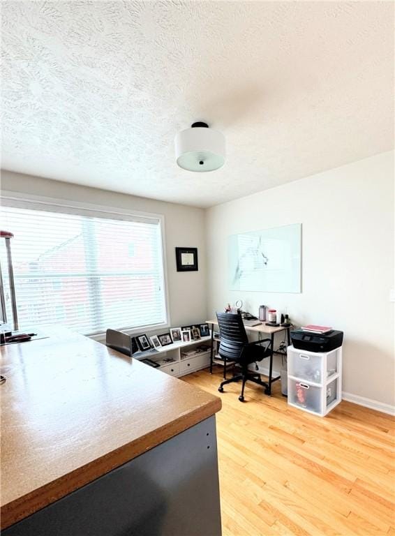 office space featuring a textured ceiling and hardwood / wood-style floors