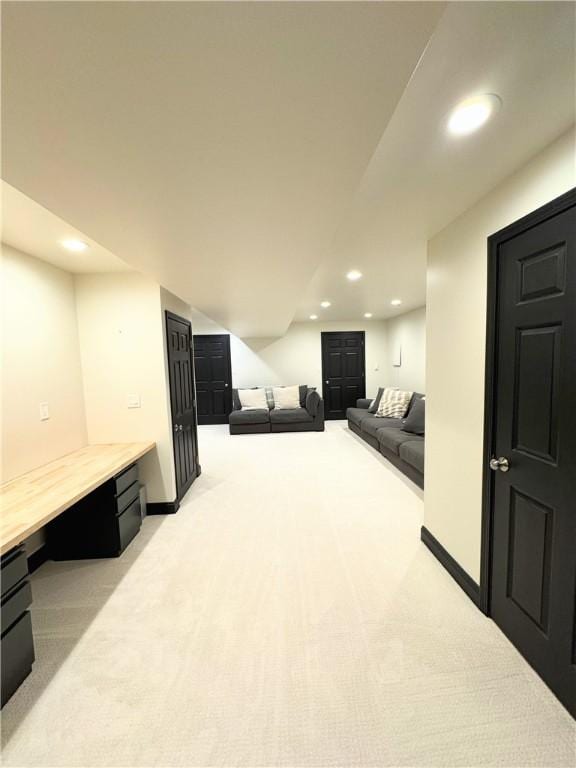 basement featuring light carpet