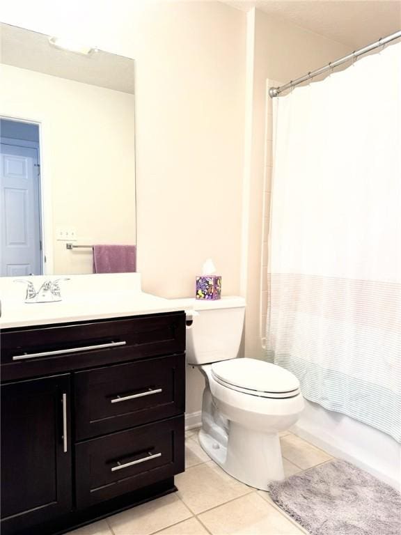 full bathroom with shower / bathtub combination with curtain, vanity, toilet, and tile patterned flooring