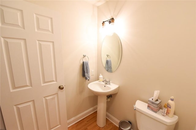 bathroom featuring hardwood / wood-style flooring and toilet