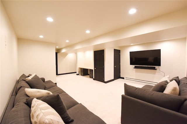 home theater with baseboard heating and light carpet