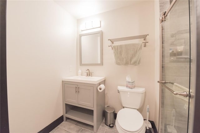 bathroom with vanity, toilet, tile patterned flooring, and a shower with door