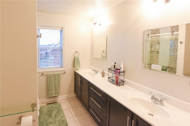 bathroom with walk in shower, vanity, and tile patterned flooring