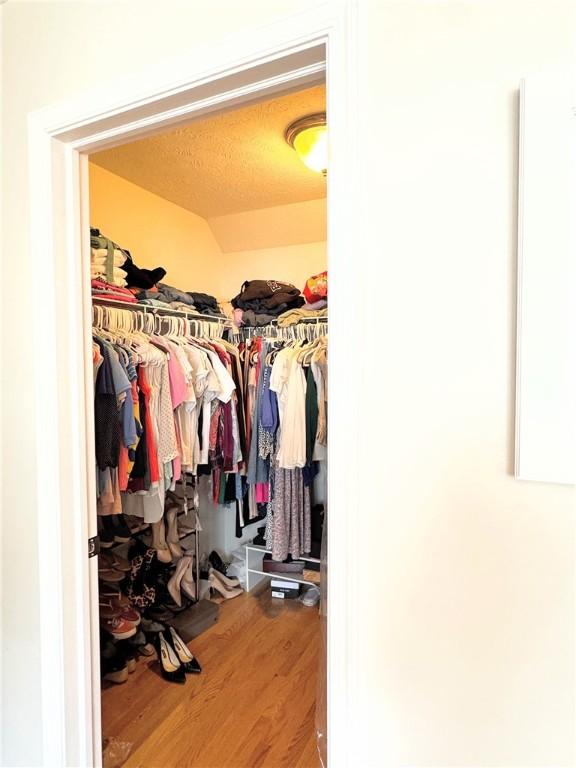 spacious closet featuring hardwood / wood-style floors