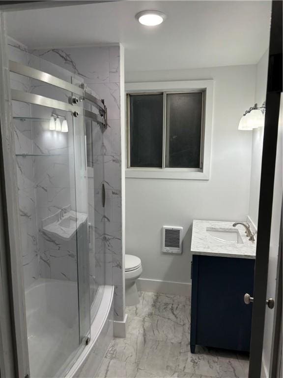 bathroom with vanity, a shower with shower door, and toilet