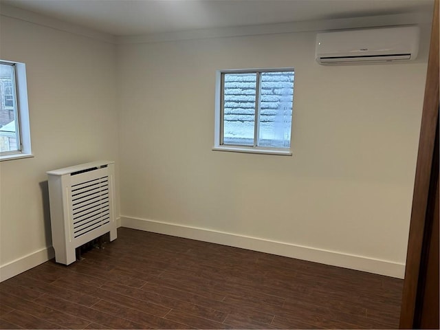 spare room with crown molding, dark hardwood / wood-style flooring, heating unit, and an AC wall unit