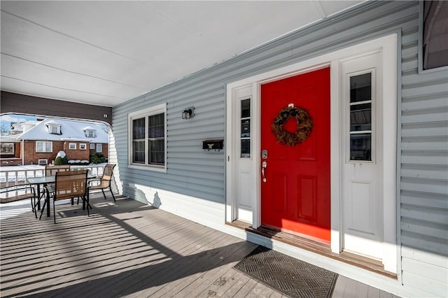 doorway to property featuring covered porch