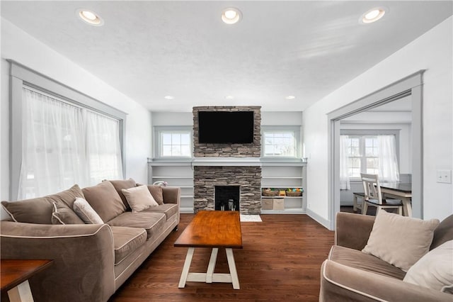 living room featuring dark hardwood / wood-style flooring and a fireplace