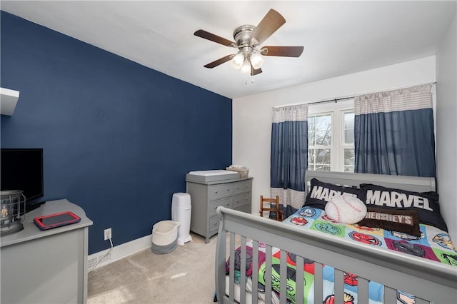 bedroom with ceiling fan and light carpet