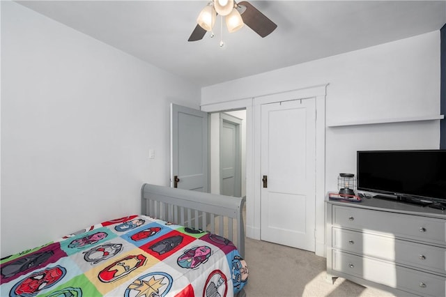 bedroom featuring light carpet and ceiling fan