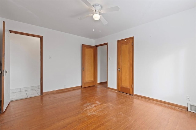 empty room featuring ceiling fan and light wood-type flooring